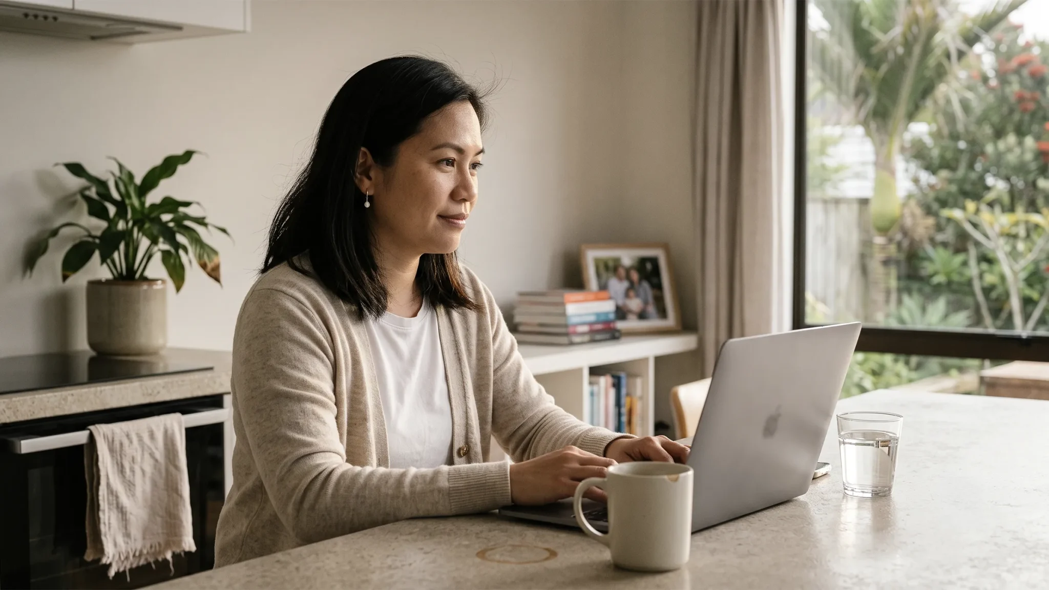 Person reviewing debt consolidation options on a laptop at home in NZ, Lending Room